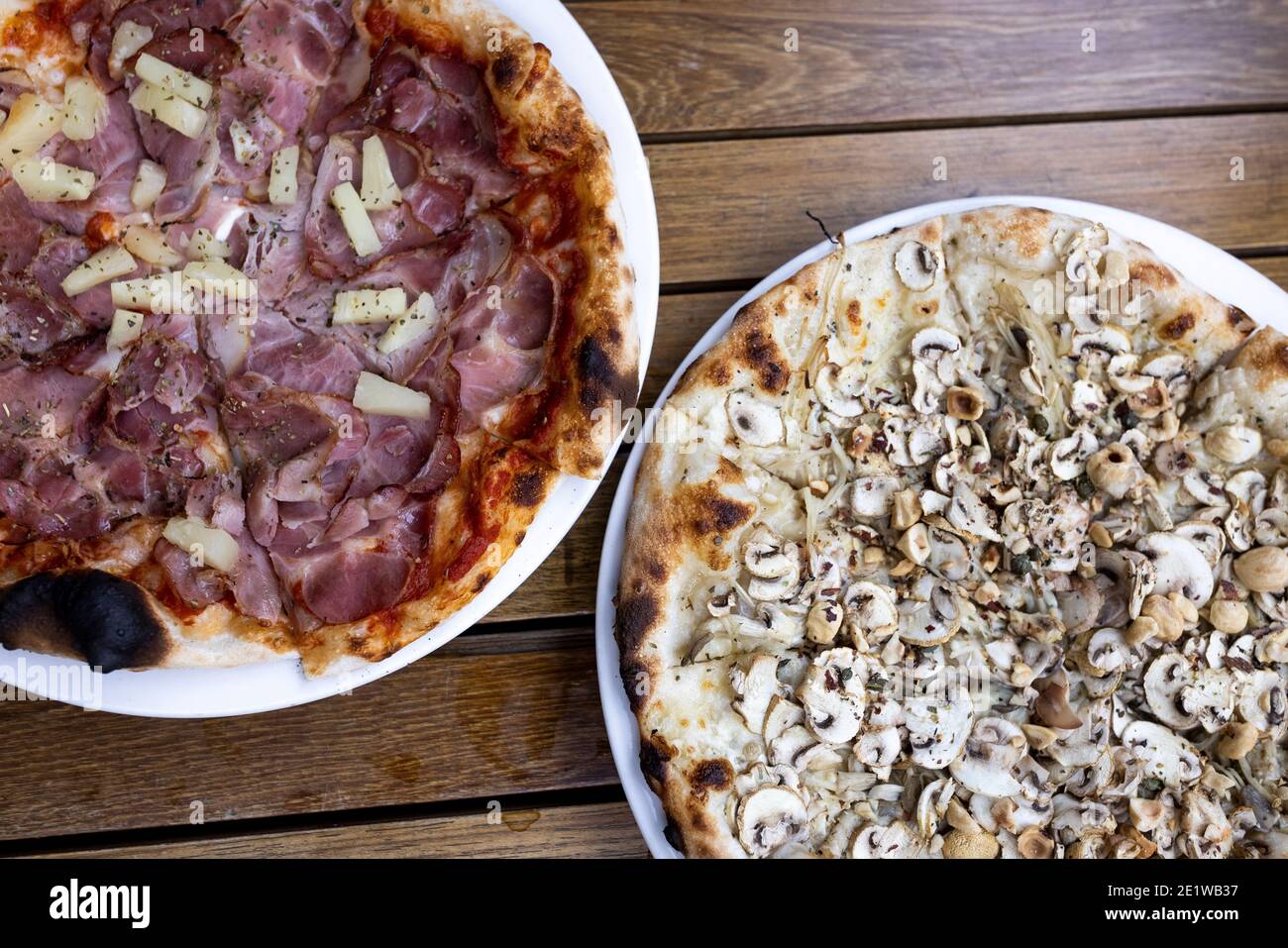 Overhead view of ham and pineapple and mushroom and onion pizzas Stock Photo