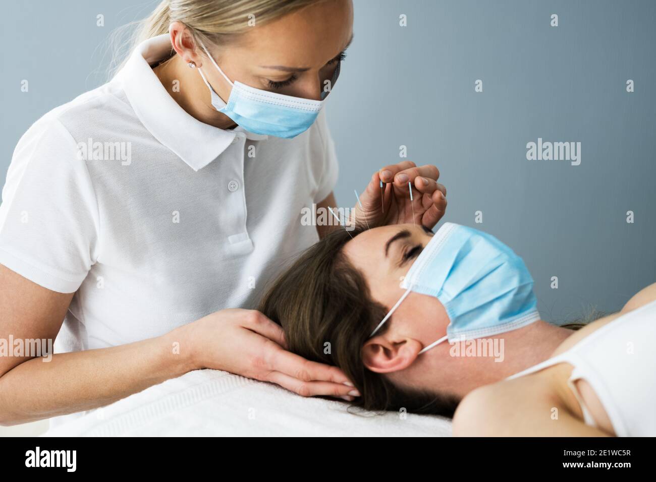 Acupuncture Woman Face Close Up In Face Mask Stock Photo