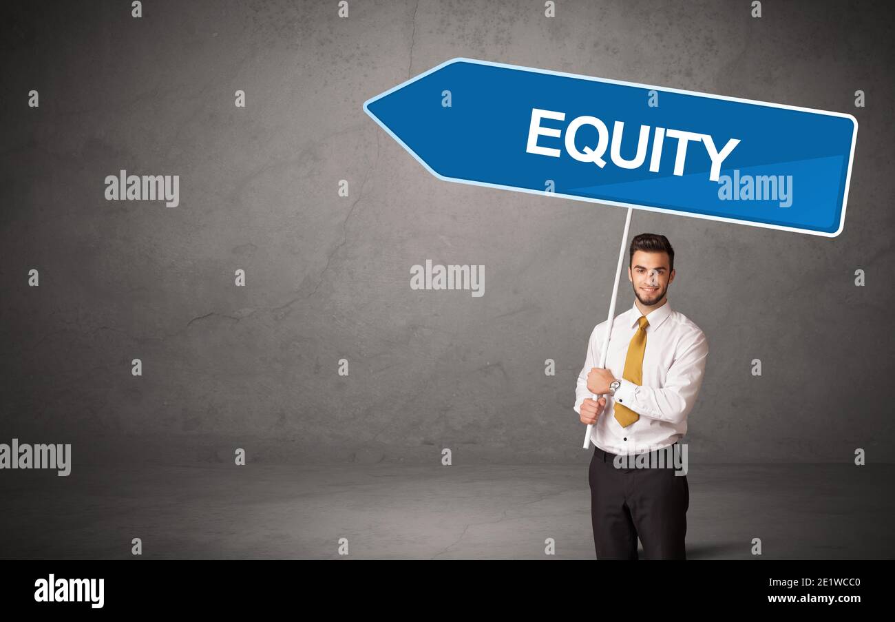 Young business person in casual holding road sign with EQUITY ...