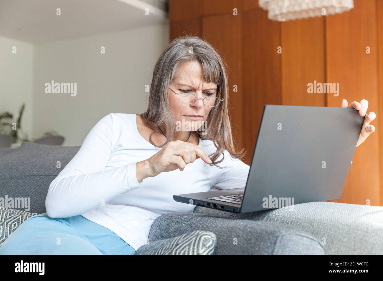 Grandma happy with her new computer as she is using to connect with her ...