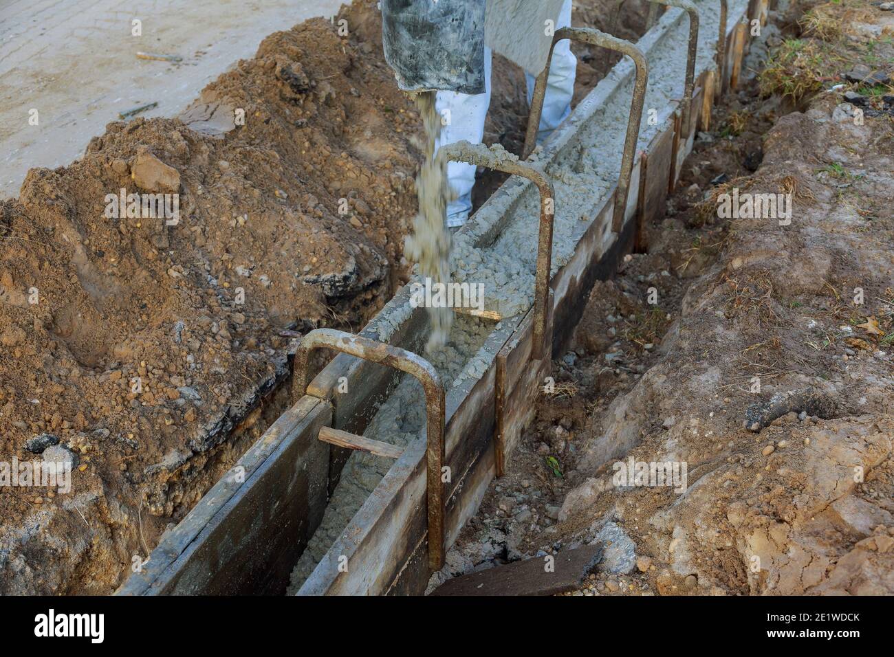 Mixed concrete pouring at construction cement during sidewalk ready