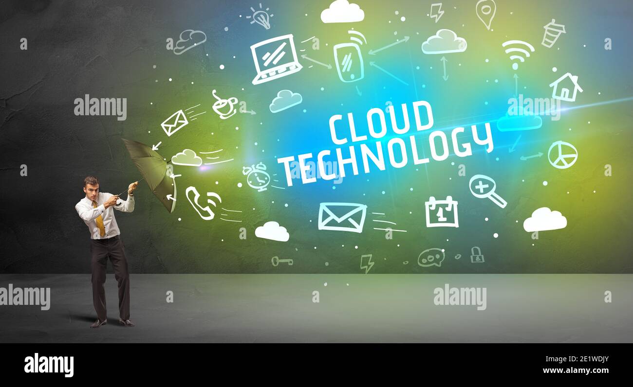 Businessman defending with umbrella from CLOUD TECHNOLOGY inscription, modern technology concept Stock Photo