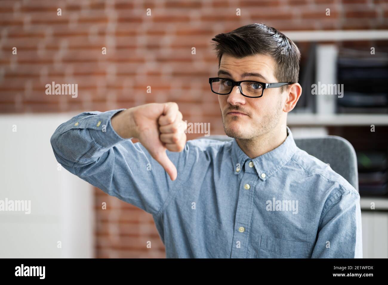 Man Portrait Showing Dislike Thumbs Down Negative Feedback Stock Photo