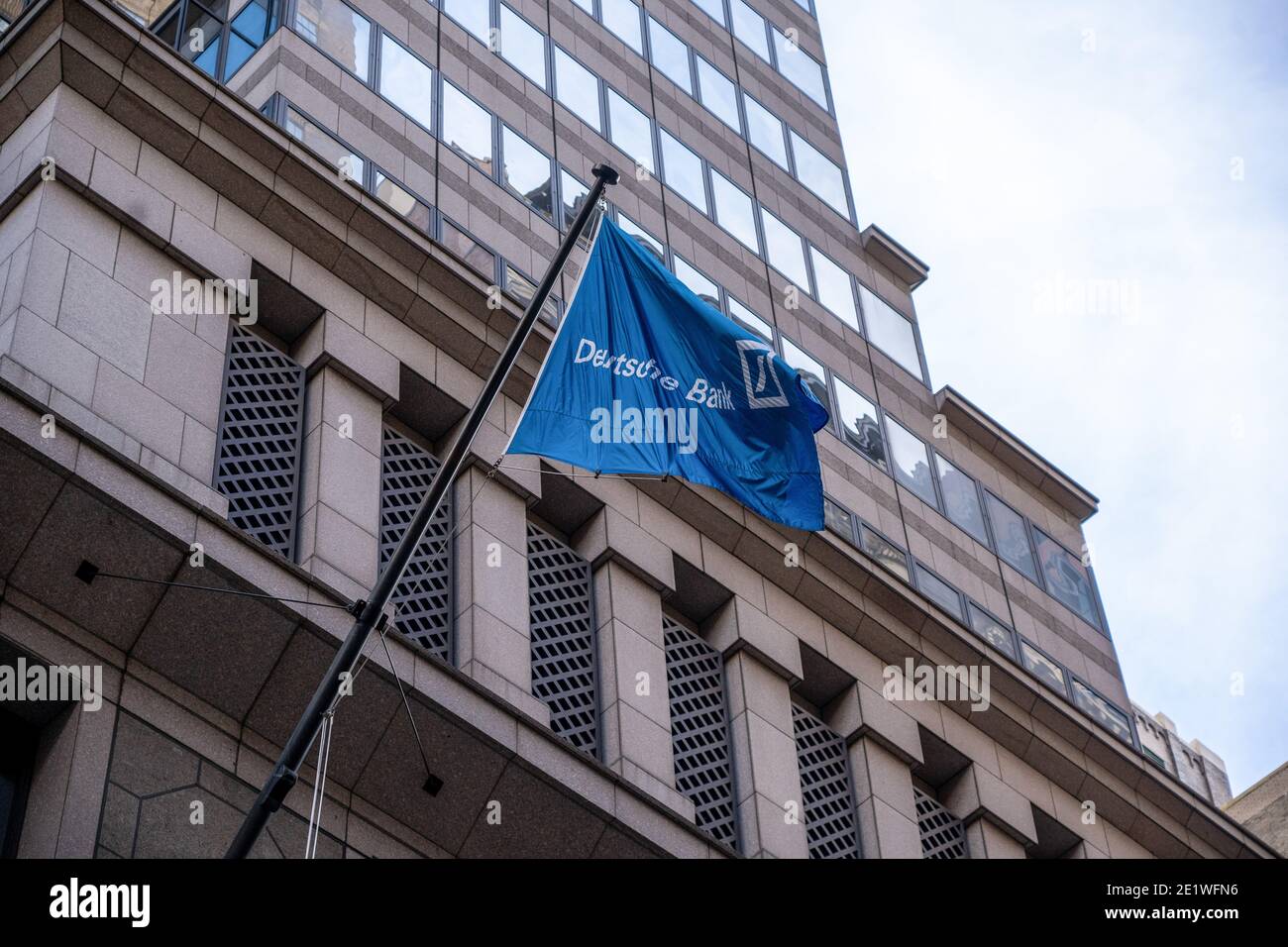 New York, United States. 09th Jan, 2021. Deutsche Bank flag hangs from Deutsche Bank AG New York Headquarters on Wall Street in New York City. Deutsche Bank AG has agreed to pay more than $130 million to settle criminal and civil charges resulting the Federal government's investigation into bribery of foreign officials and manipulated the market for precious-metals futures through a trading tactic known as spoofing. Deutsche Bank AG is still under investigation by New York State for its dealing with Trump Organization. Credit: SOPA Images Limited/Alamy Live News Stock Photo