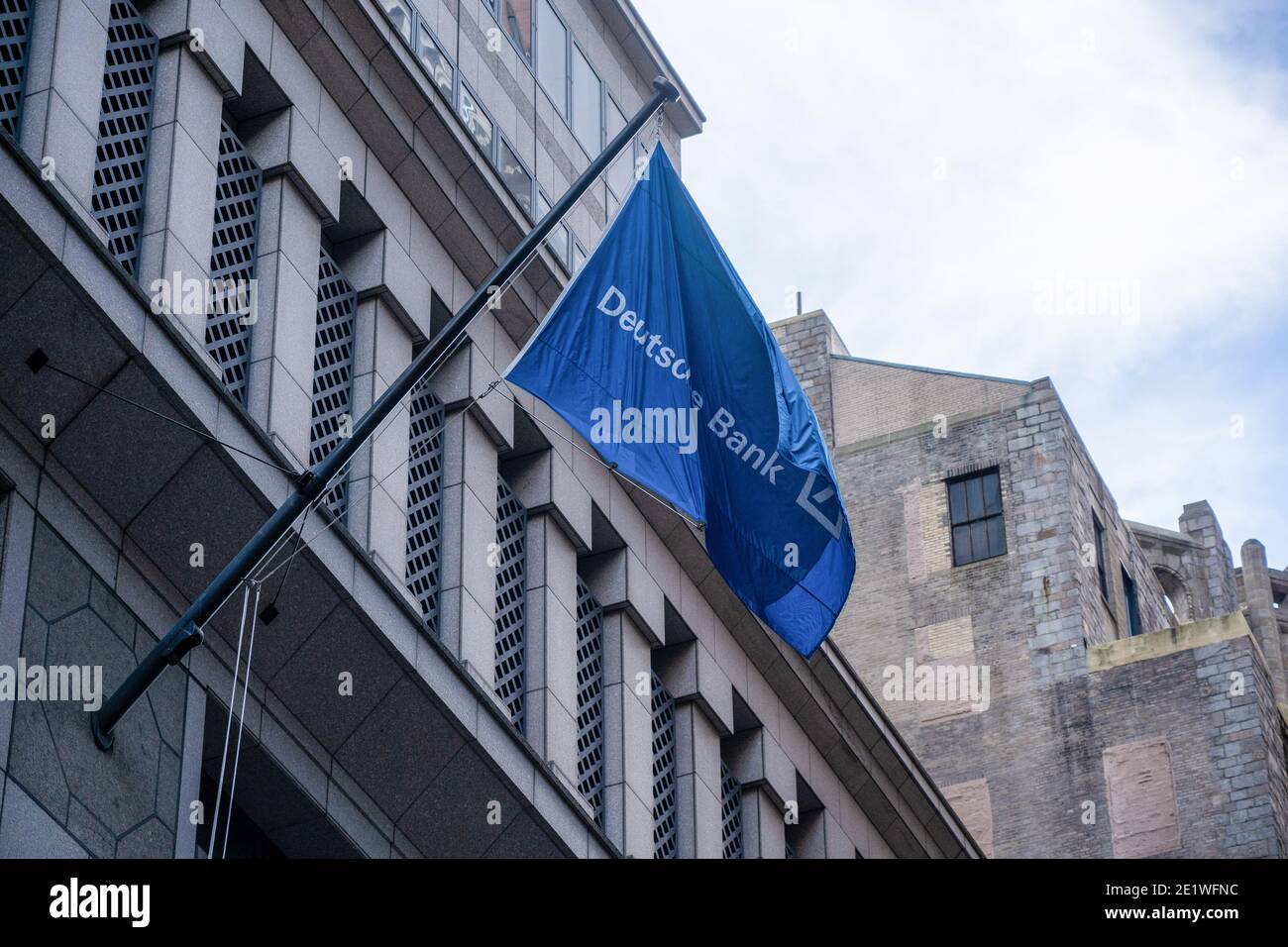New York, United States. 09th Jan, 2021. Deutsche Bank flag hangs from Deutsche Bank AG New York Headquarters on Wall Street in New York City. Deutsche Bank AG has agreed to pay more than $130 million to settle criminal and civil charges resulting the Federal government's investigation into bribery of foreign officials and manipulated the market for precious-metals futures through a trading tactic known as spoofing. Deutsche Bank AG is still under investigation by New York State for its dealing with Trump Organization. Credit: SOPA Images Limited/Alamy Live News Stock Photo