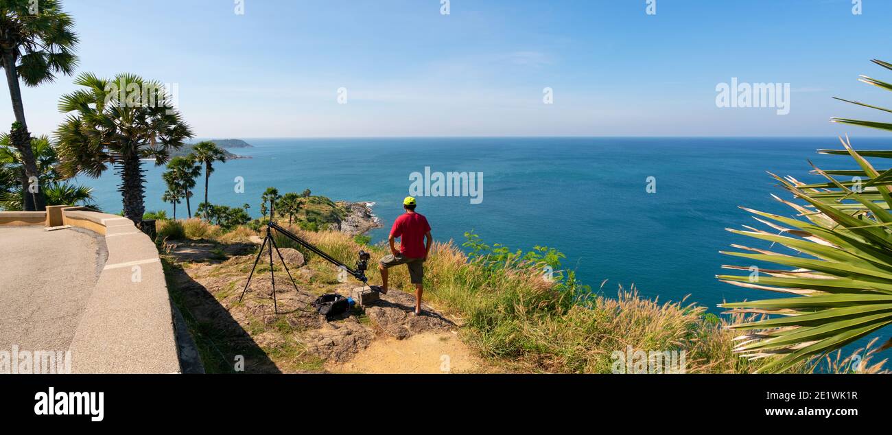 Professional man setting Slider dolly camera taking picture Landscape nature view at Laem Promthep cape Phuket Thailand,Landmark famous tourist destin Stock Photo
