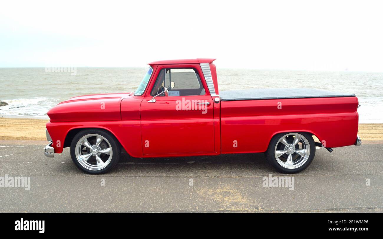 Classic Red  Chevrolet pickup truck on seafront promenade. Stock Photo
