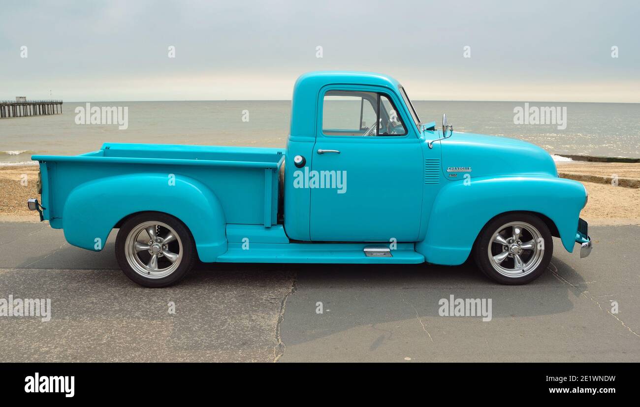 Classic Light Blue  Chevrolet 3100 pickup truck on seafront promenade with sea in background Stock Photo