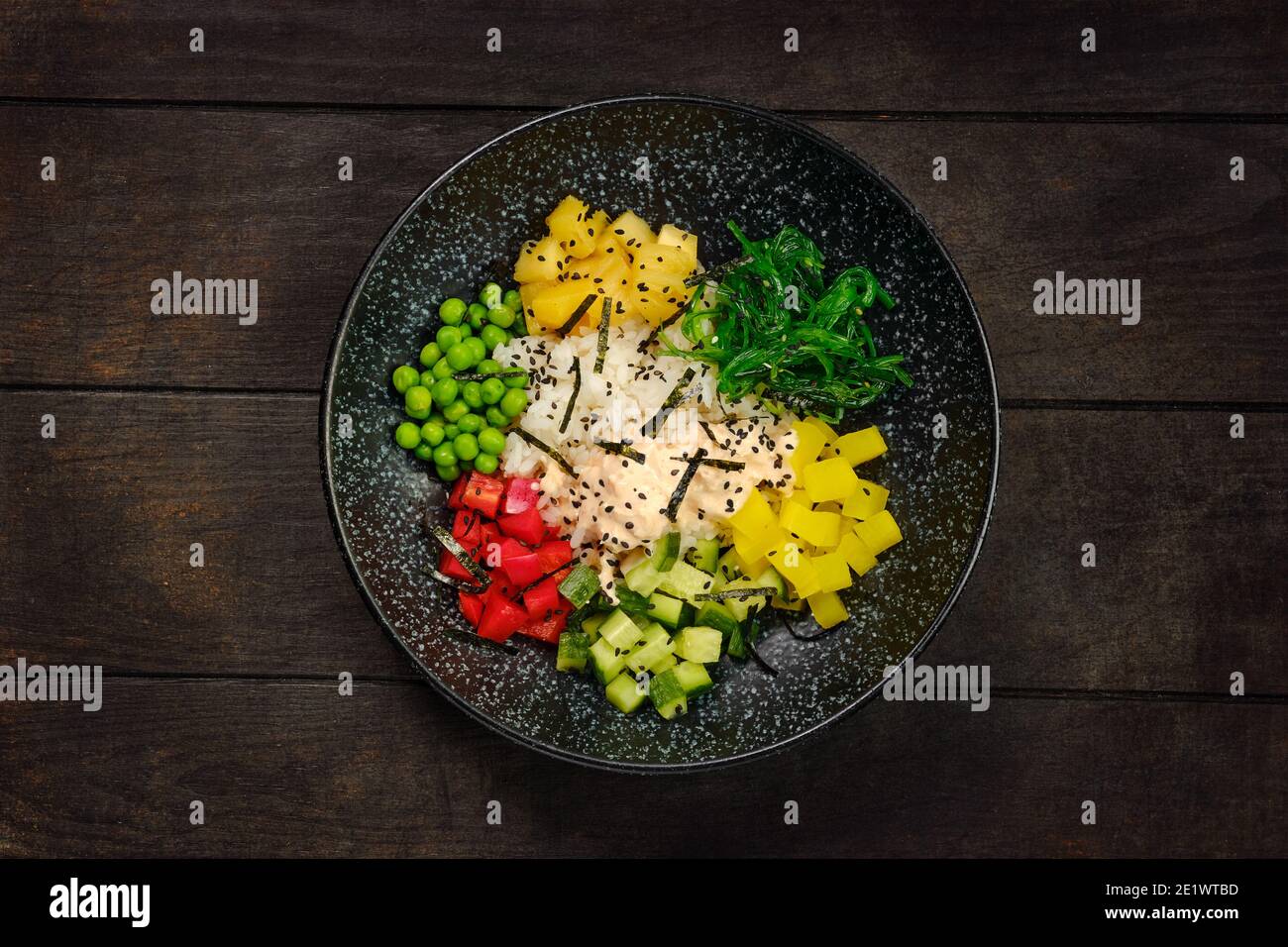 Top view of plate with salad ingredients chicken, rice, bell pepper