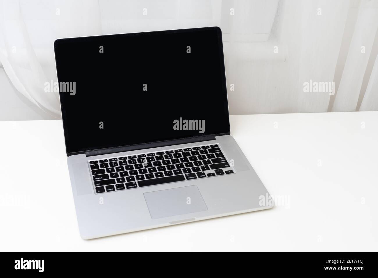 Computer mockup white background on table. Laptop with blank screen Stock Photo