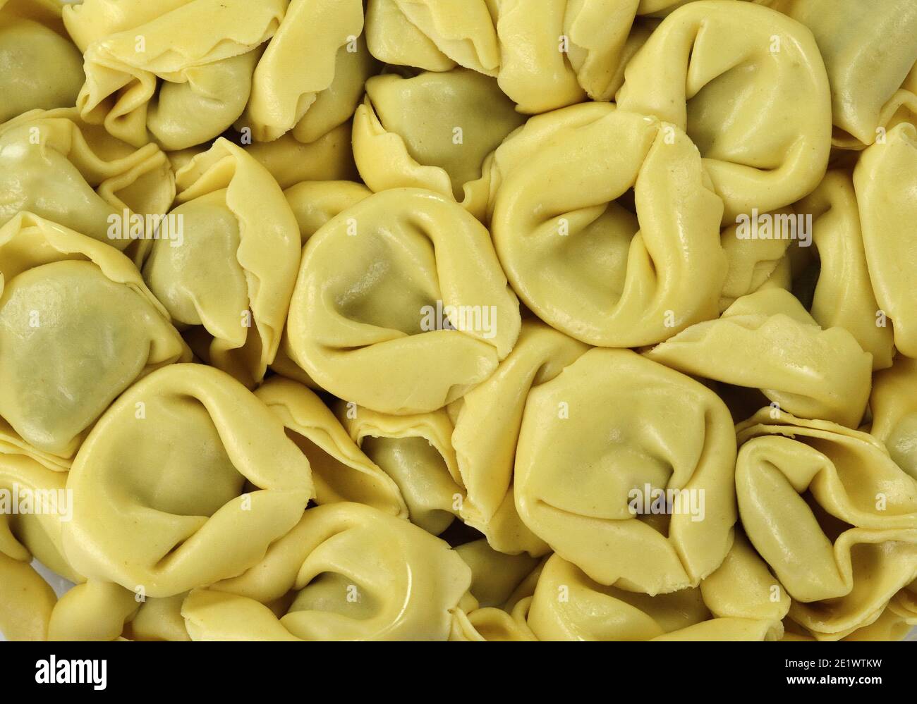 Italian traditional tortellini pasta or ravioli stuffed with spinach isolated on white