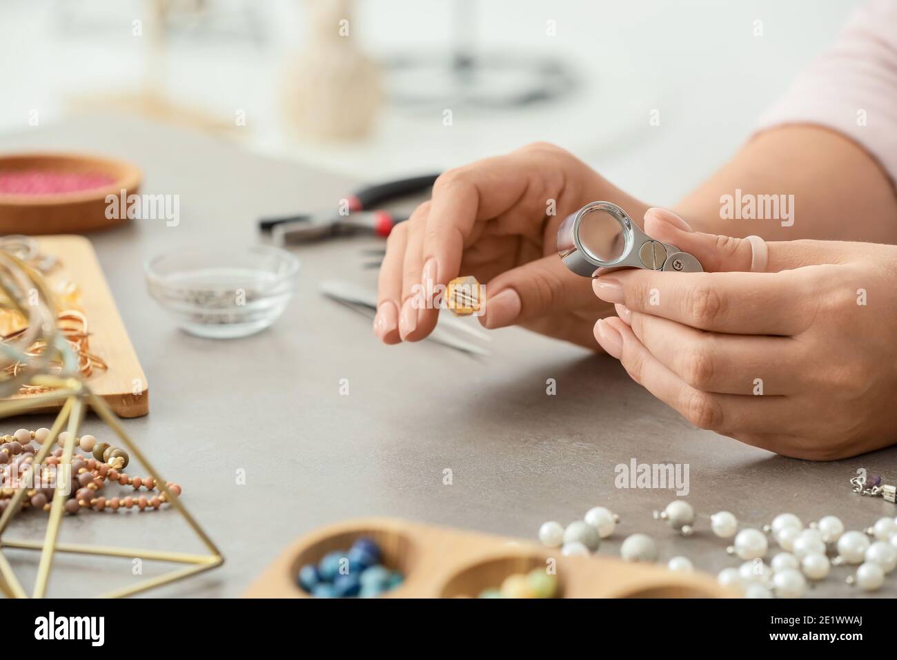 Female designer making jewelry at workplace Stock Photo Alamy