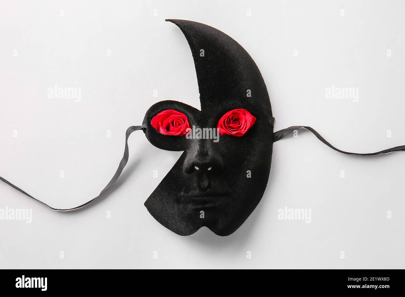 Mask and beautiful red roses on white background Stock Photo - Alamy