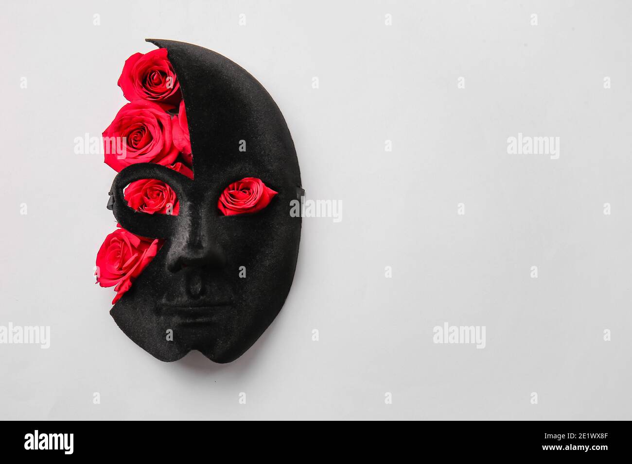 Mask and beautiful red roses on white background Stock Photo - Alamy