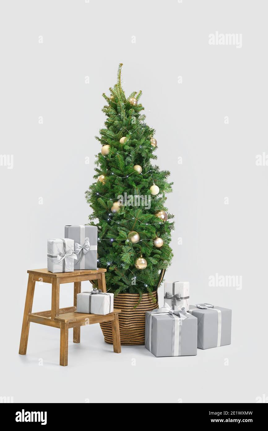 Beautiful decorated Christmas tree with gift boxes on white background ...