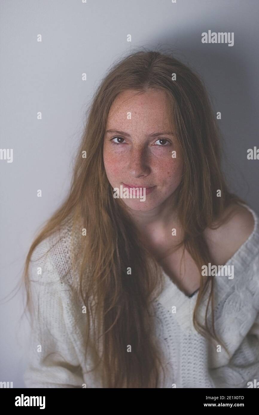 Portrait of a blonde girl with freckles without makeup Stock Photo