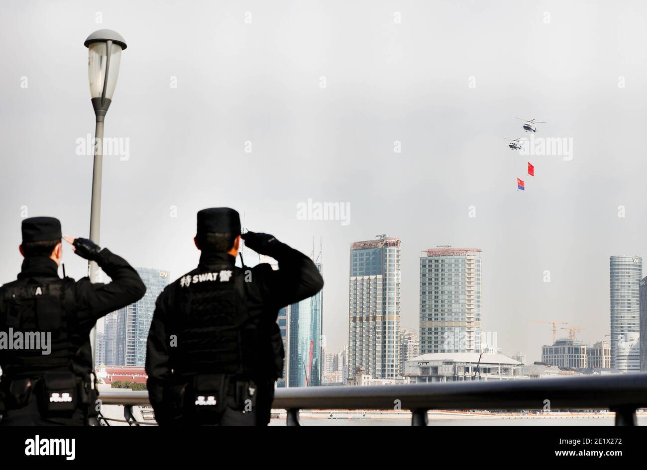 Shanghai. 10th Jan, 2021. Two police officers salute to the Chinese national flag and the police flag hanging on helicopters in east China's Shanghai, Jan. 10, 2021. Activities were held to mark the first Chinese People's Police Day, which falls on Sunday. Credit: Fang Zhe/Xinhua/Alamy Live News Stock Photo