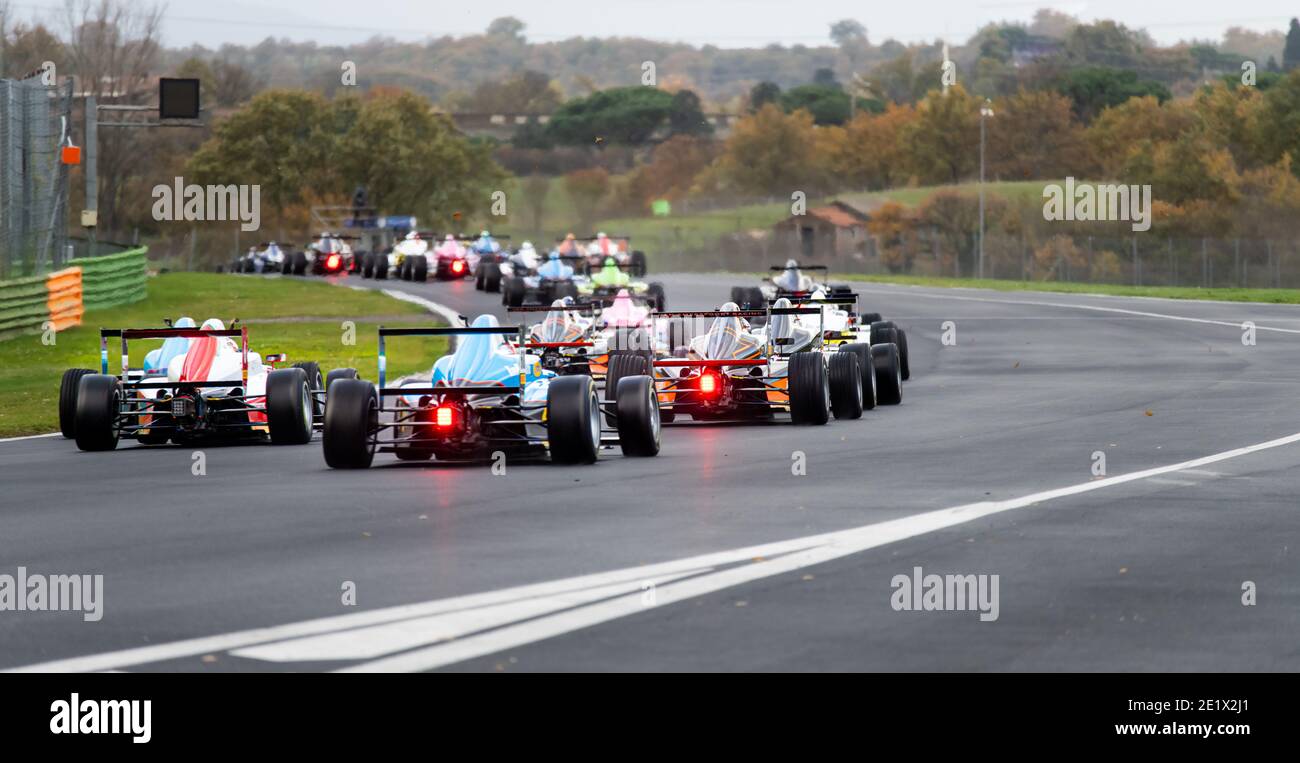 Vallelunga, Italy 5 december 2020, Aci racing weekend. Rear view of motorsport racing competition cars few seconds after race start, Formula cars with Stock Photo