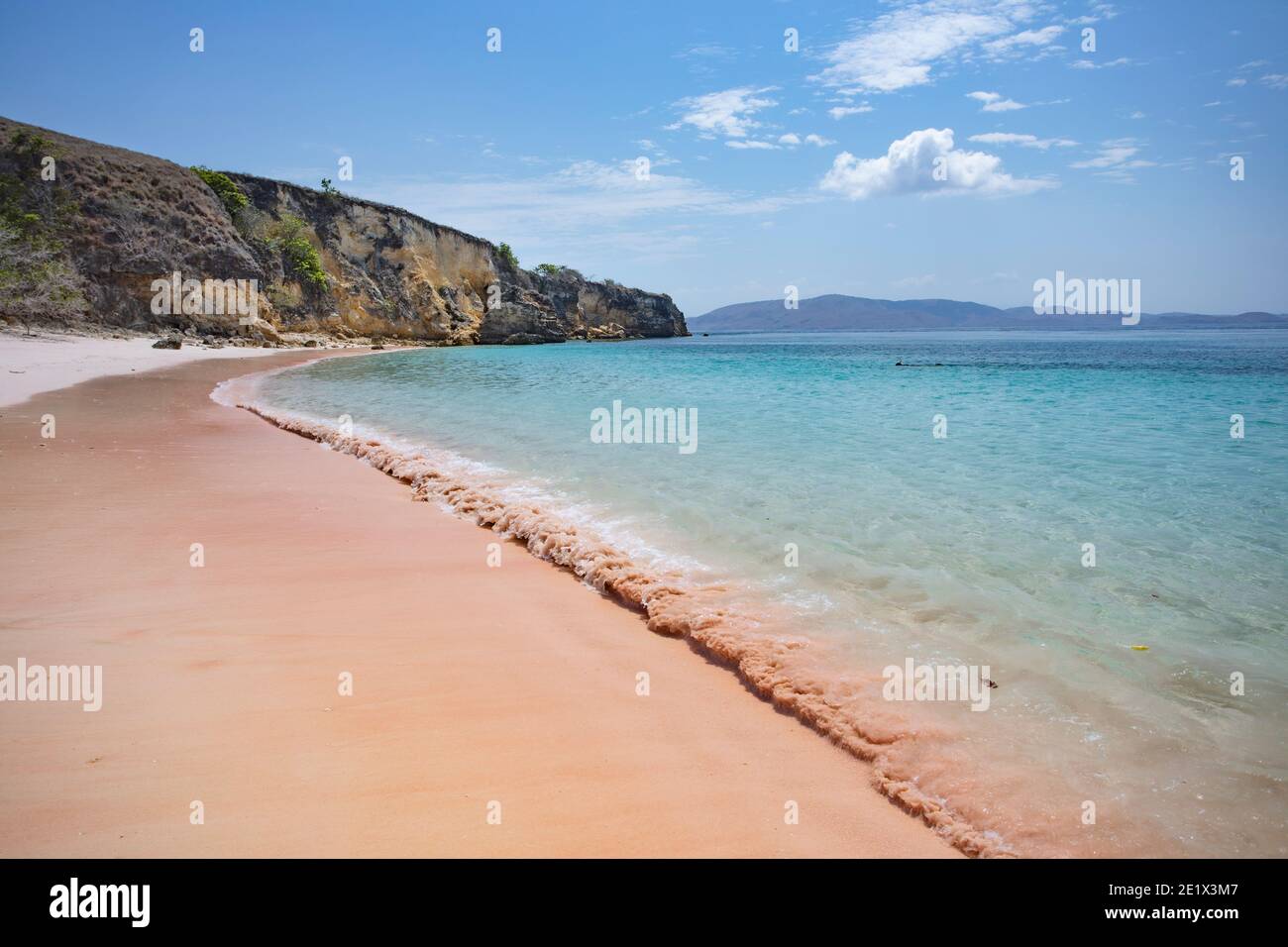 soft waves crashing on the remote pink beach in Komodo National Park in Indonesia Stock Photo