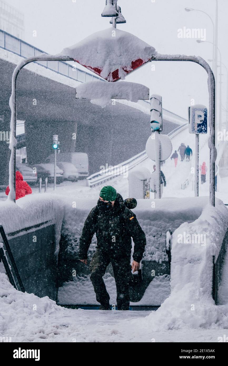 Madrid, Spain - January 2021: Pacifico Underground Metro station covered in snow due to Filomena Storm with a soldier of Unidad Militar de Emergencias Stock Photo
