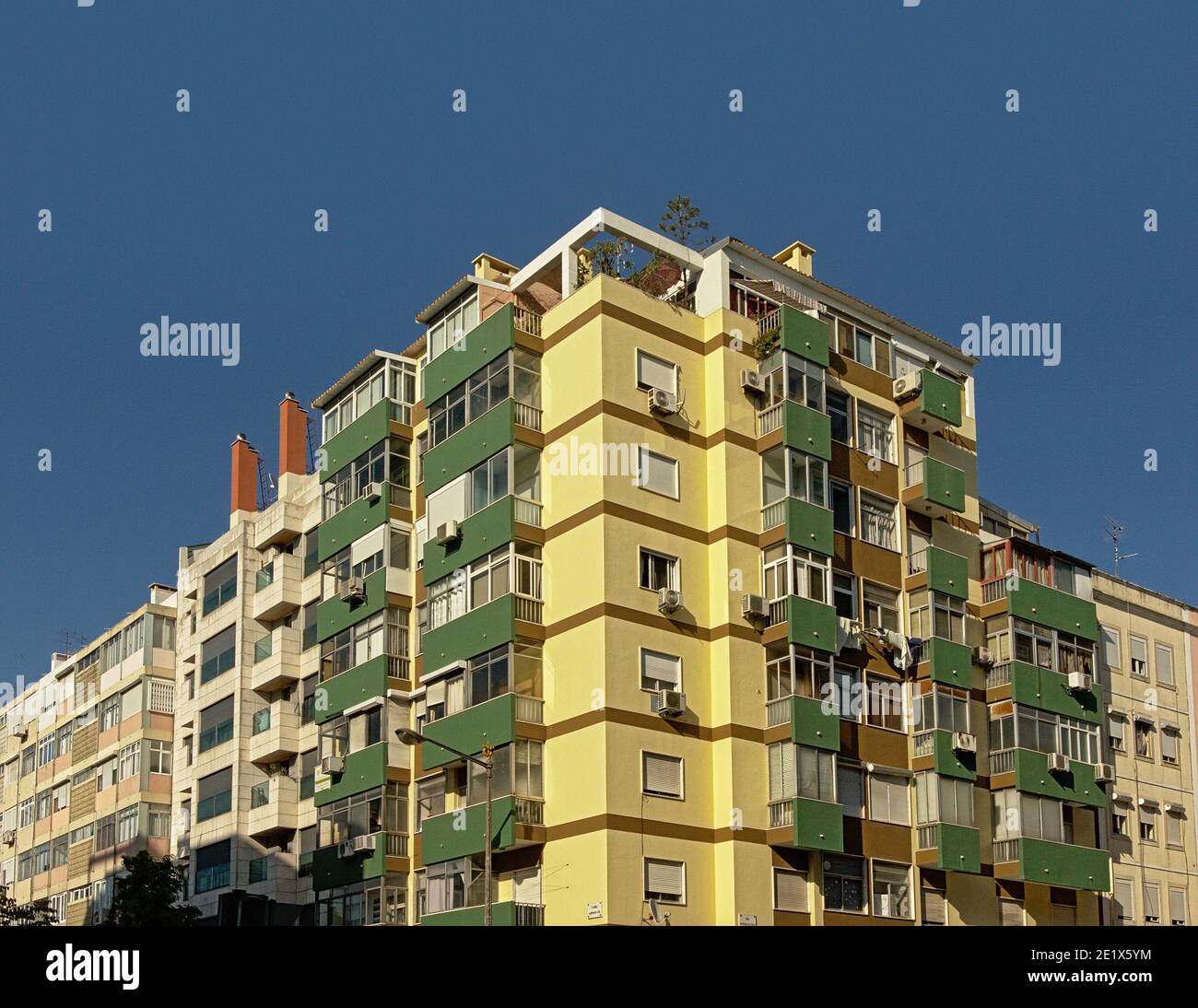 Detail of typical modern portuguese apartment building in yellow and ...