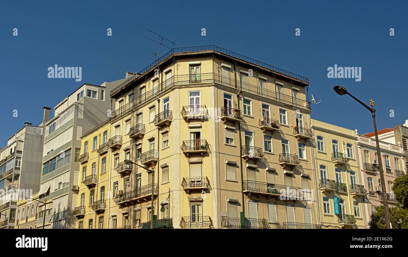 Detail of typical portuguese apartment building in yellow pastel color ...