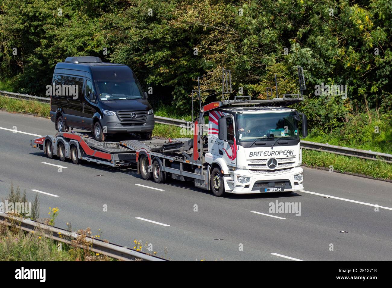 Brit European car transporter drivers:  Vehicle delivery trucks carrying Mercedes Benz sprint on lorry trailer, heavy-duty vehicles, transportation, truck, car carrier vehicle, European commercial transport industry HGV, M6 at Manchester, UK Stock Photo