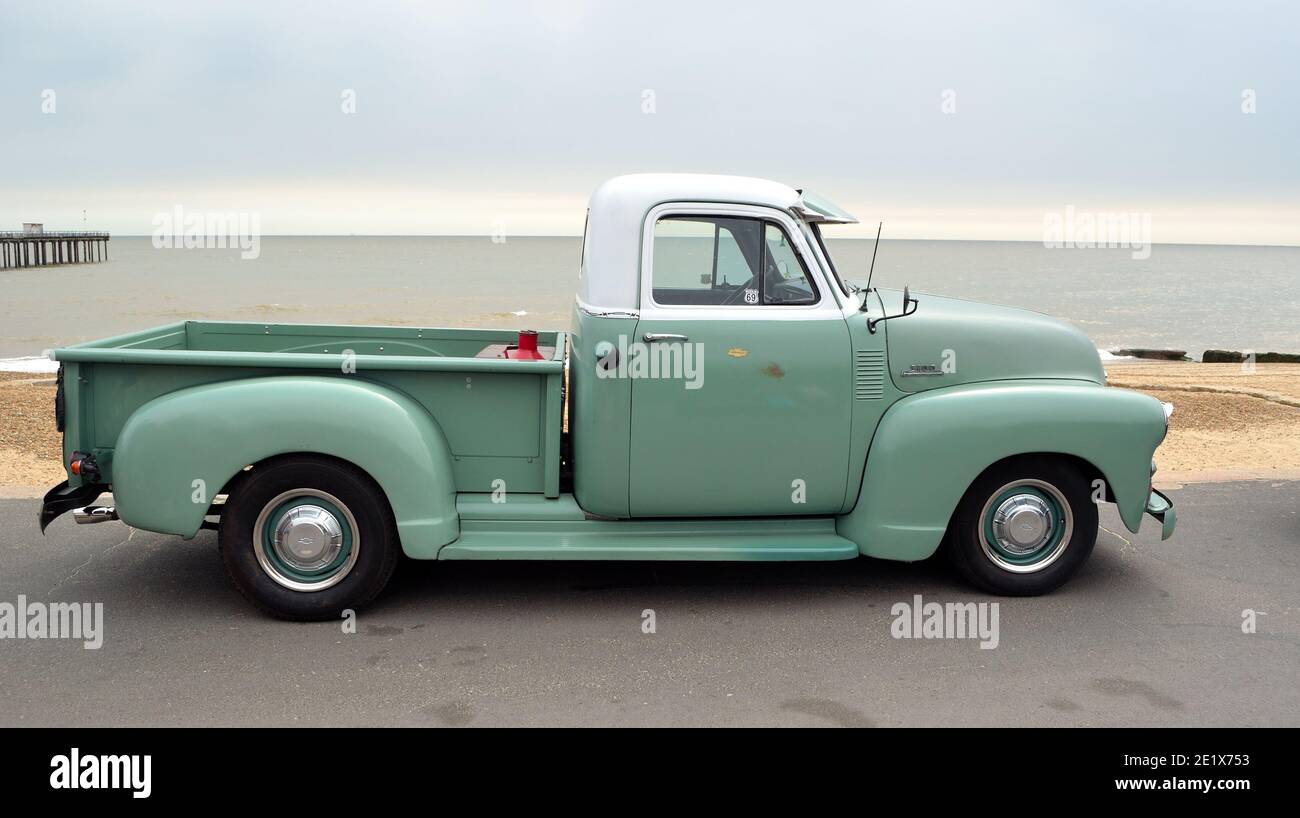 Classic Green and White  Chevrolet 3100 pickup truck on seafront promenade. Stock Photo