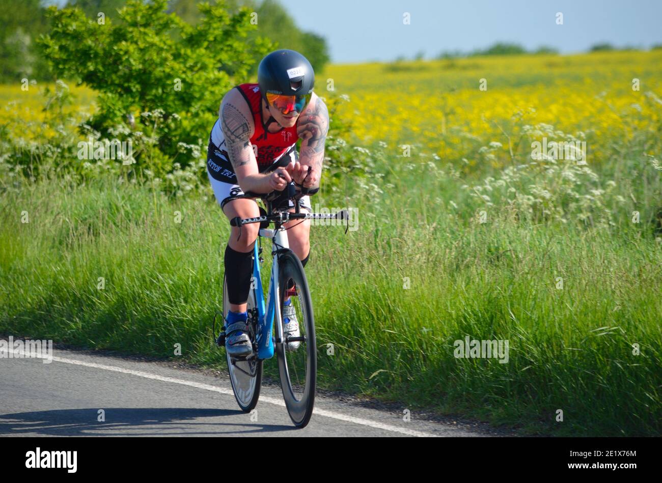 Close up of Male triathlete  competitor on road cycling stage. Stock Photo