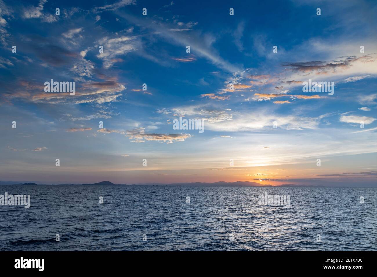 beautiful horizon on the ocean with dramatic clouds in the sky at sunset Stock Photo