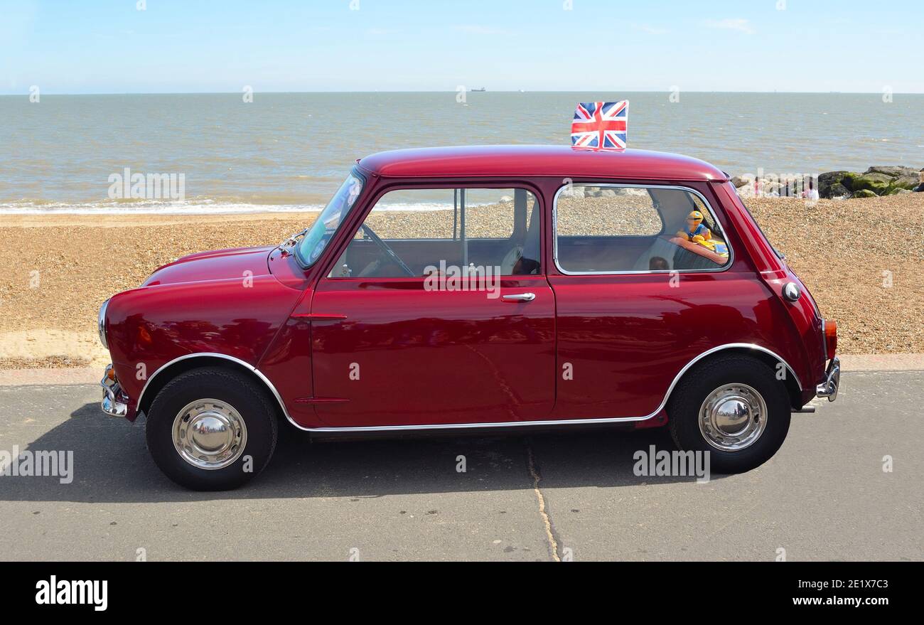 Classic Red Austin Mini motor car parked on  Felixstowe seafront promenade. Stock Photo