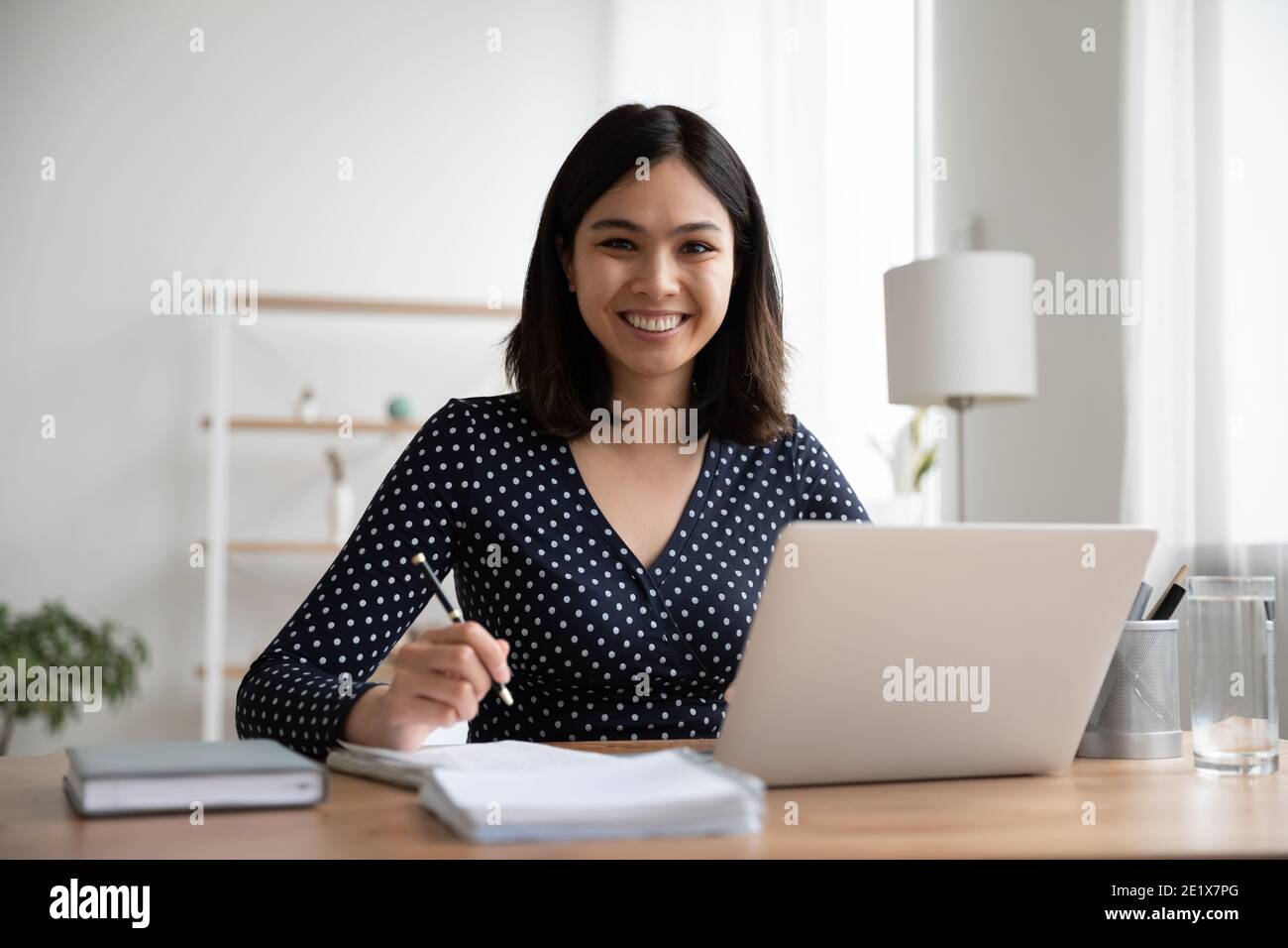 Happy asian mixed race student studying distantly on online courses. Stock Photo