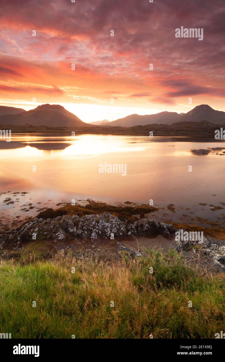 Reflection of mountains in bay in Connemara on the Wild Atlantic Way in Galway in Ireland. Stock Photo