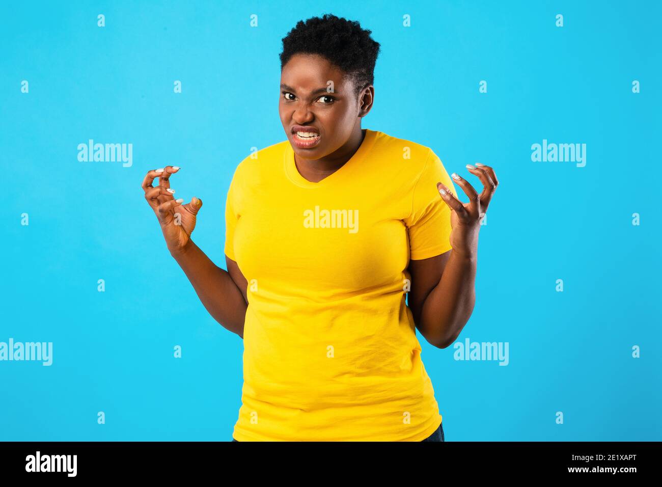 Mad African Woman Freaking Out Looking Angrily Posing, Blue Background Stock Photo