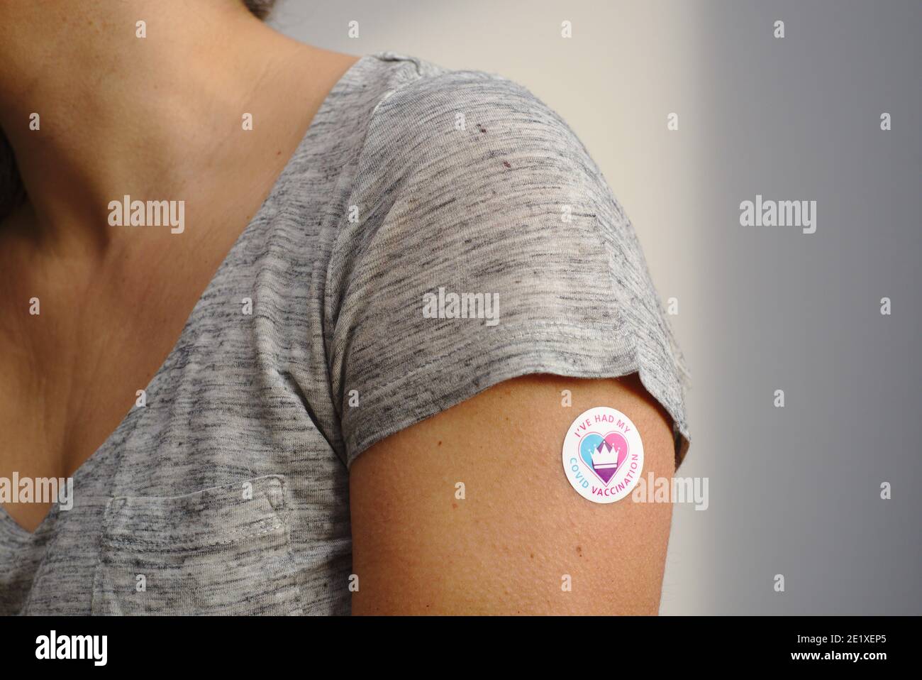 Sticker saying I've had my Covid Vaccination on arm of vaccine recipient. Stock Photo