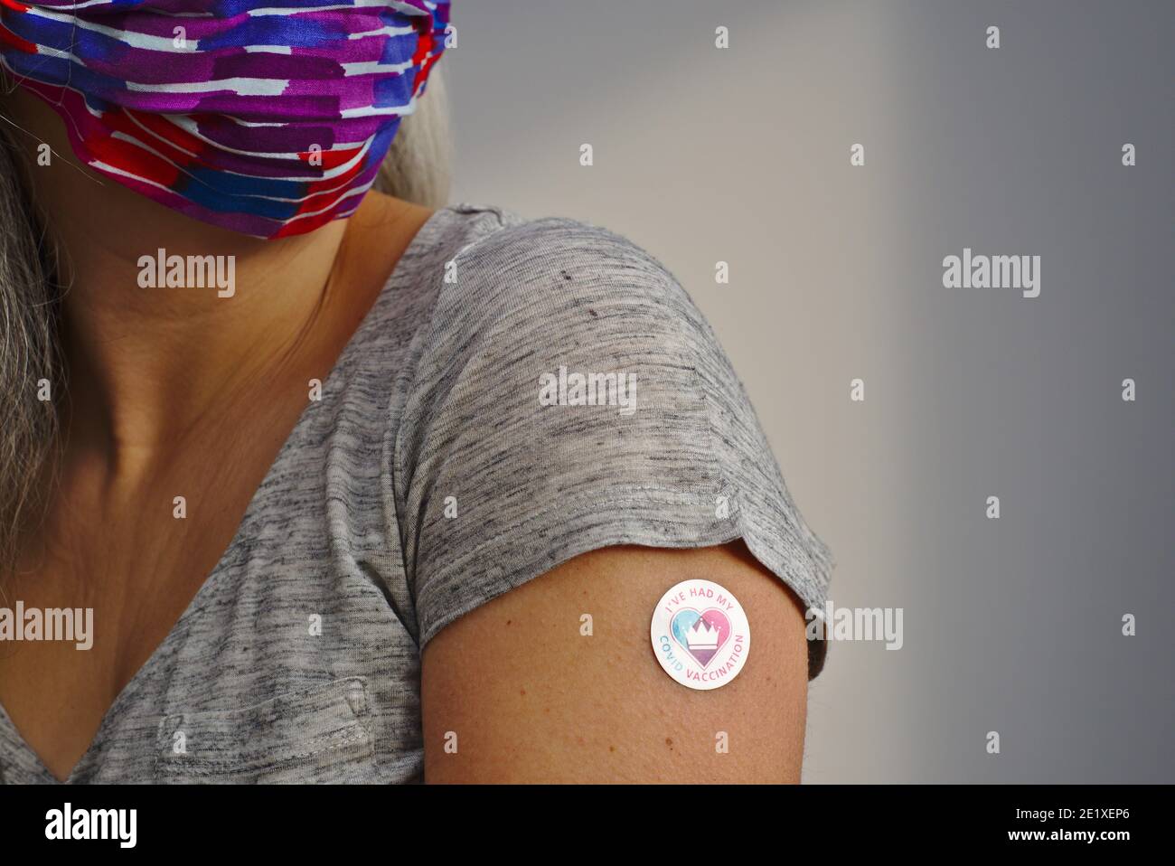 Woman wearing Covid19 mask has had her covid vaccination. Stock Photo