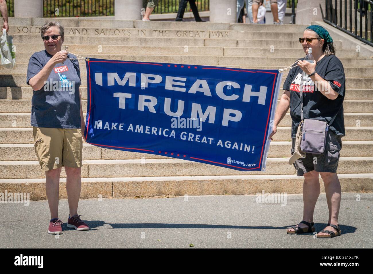 Boston, Massachusetts, US-June 15, 2019: Protesters hold signs reading 'Impeach Trump' Stock Photo