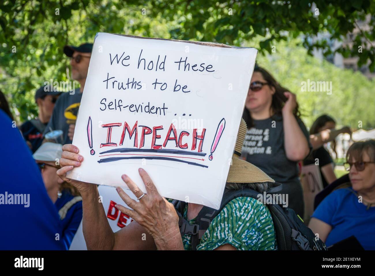 Boston, Massachusetts, US-June 15, 2019: Protesters hold signs reading 'Impeach Trump' Stock Photo