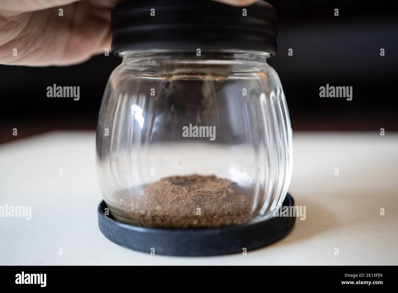 Grinding coffee beans with manual grinder Stock Photo