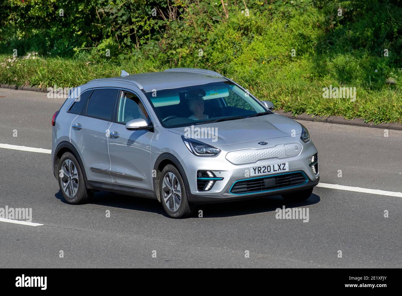 2020 Kia Electricity Niro 4 Ev silver SUV ; Vehicular traffic, moving