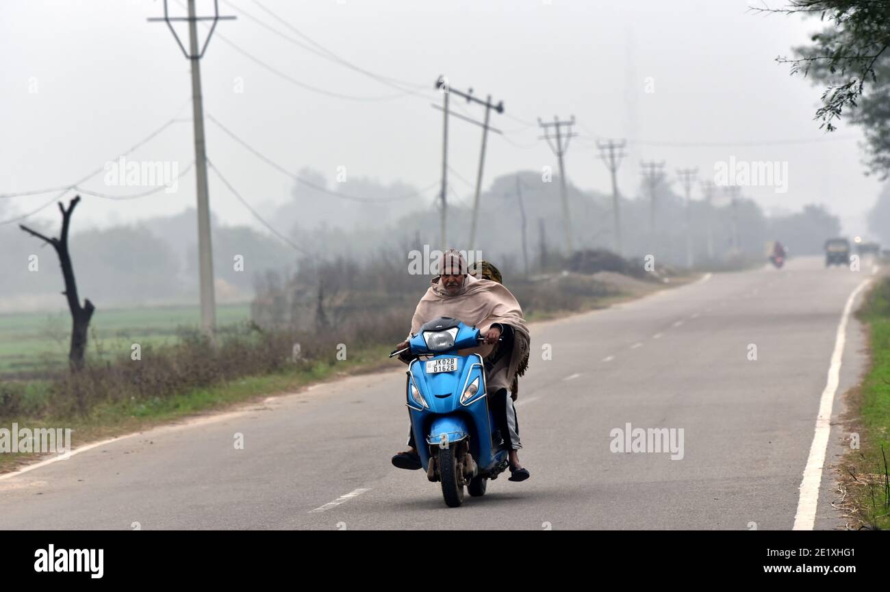 Jammu. 10th Jan, 2021. A man rides an electromobile during cold and foggy morning in Jammu, the winter capital of Indian-controlled Kashmir, Jan.10, 2021. Credit: Str/Xinhua/Alamy Live News Stock Photo