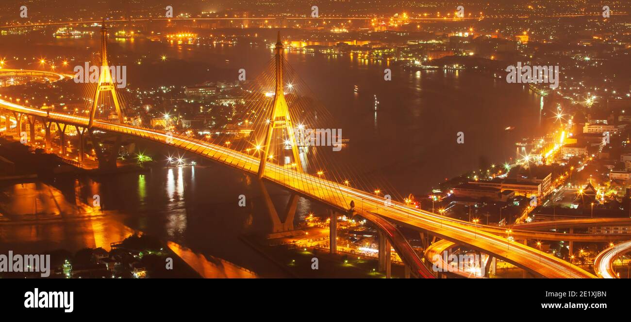 Aerial view of Bhumibol Suspension Bridges and highways interchange over Chao Phraya River at dusk. Stock Photo