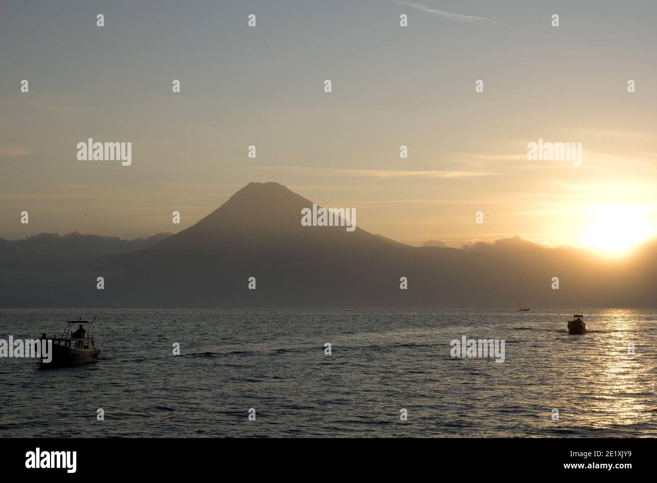 Guatemala, Central America: Lake Atitlán (Atitlan)  with volcanos - sunset with boat Stock Photo