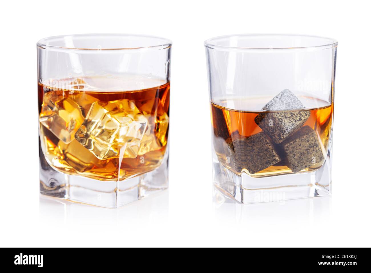 Glasses of whiskey with stones and ice isolated on white Stock Photo