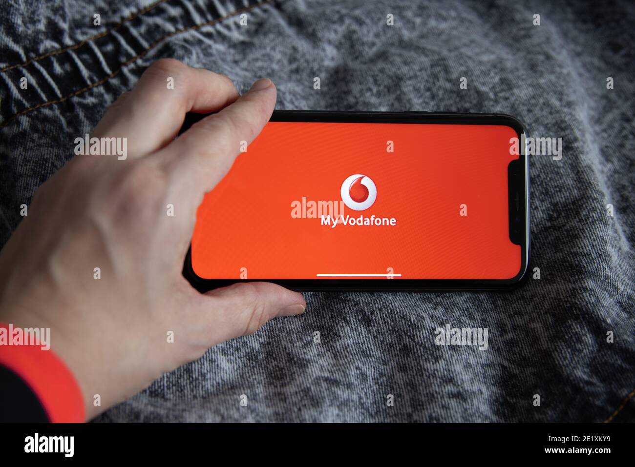 Vodafone a largest telecommunication company. Hand holding iPhone 11 with Vodafone logo. Stock Photo
