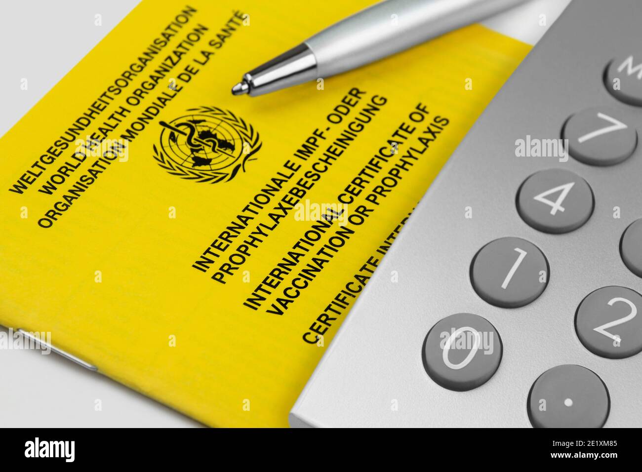 Certificate of vaccination and calculator close up Stock Photo