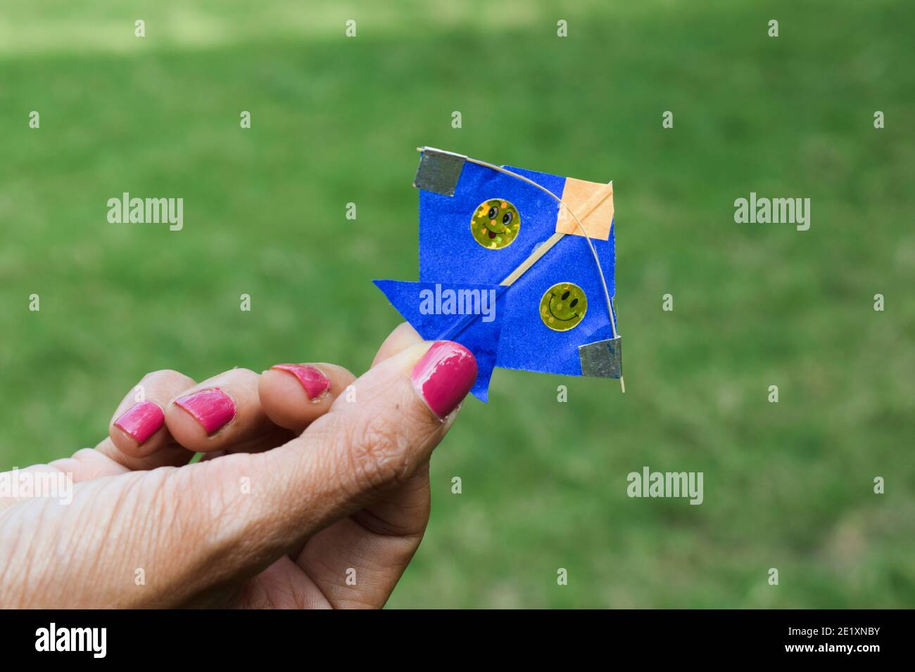 Small tiny miniature Blue color kite. Very small in size female holding