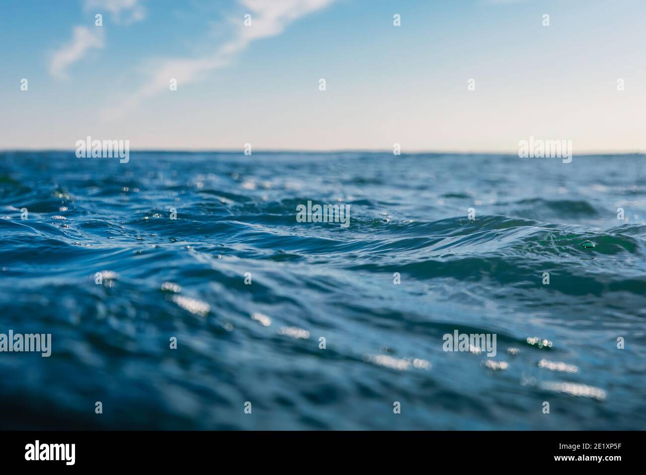 Blue waves in ocean. Water texture with bokeh Stock Photo