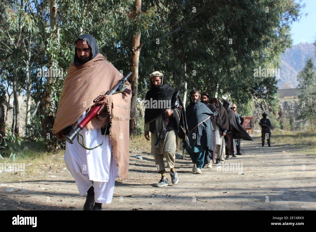 Kunar, Afghanistan. 10th Jan, 2021. Militants attend a surrender ceremony in Kunar province, Afghanistan, Jan. 10, 2021. A total of 25 Taliban militants have given up fighting and joined the government-run peace process in the eastern Kunar province on Sunday, provincial governor Iqbal Sayed said. Credit: Emran Waak/Xinhua/Alamy Live News Stock Photo