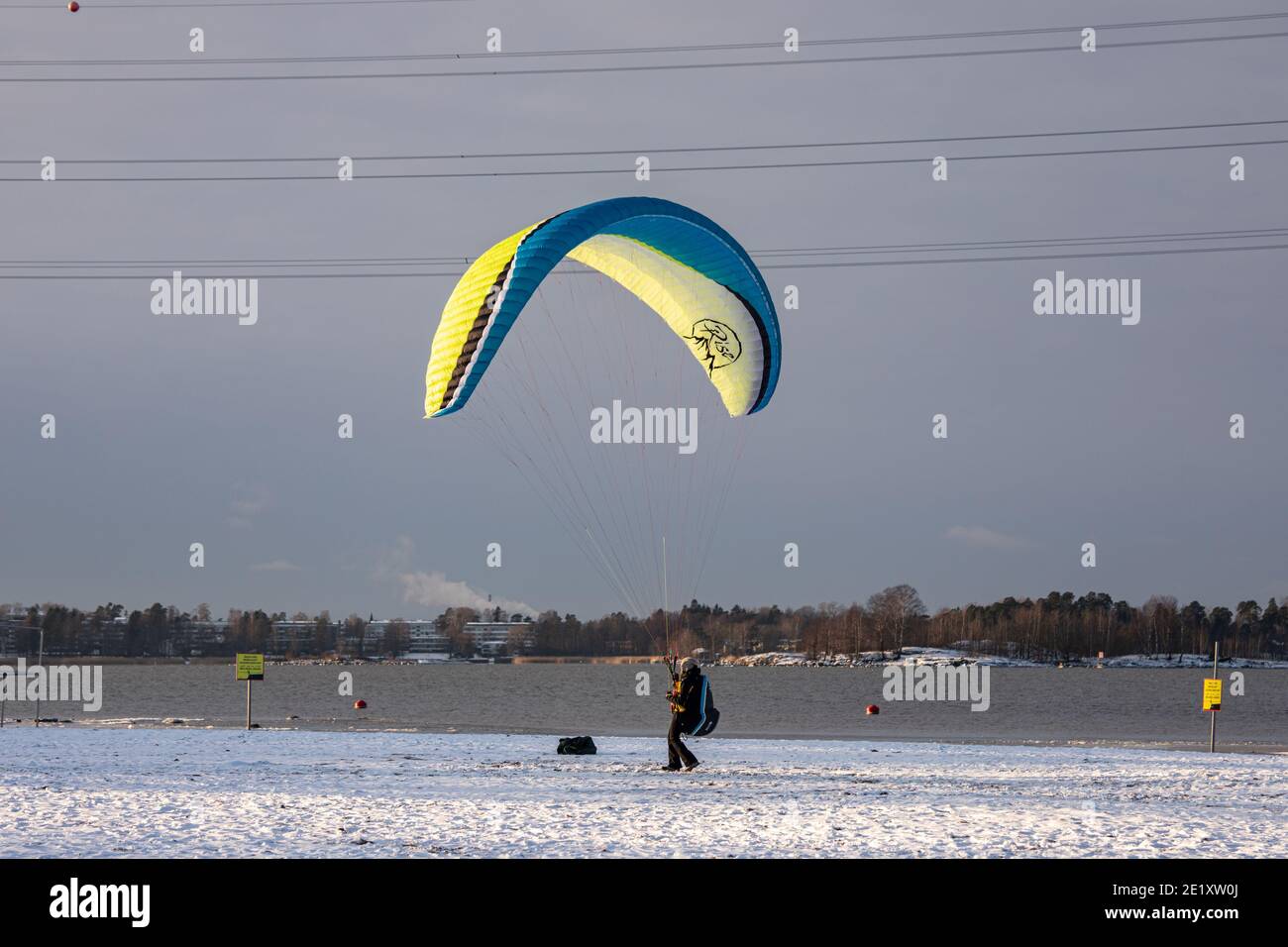 Woman practicing paraglider ground handling on Hietaranta Beach in Helsinki, Finland Stock Photo